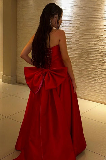 Red prom dress with lace-up corset back and oversized bow detail by Vedress