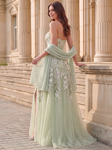 Back view of sage green strapless floral embroidered prom dress with fitted back bodice, cascading floral appliques, flowing floor-length skirt and sheer scarf.
