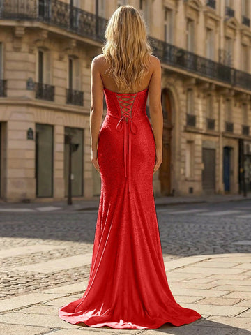 Vedress red sparkly prom dress with a low V-shaped open back, fitted silhouette, and sweep train, rear three-quarter view.