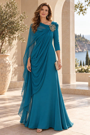 Teal blue sheath mother of the bride dress featuring asymmetrical draped neckline, jeweled shoulder accent, three-quarter sleeve, sheer cape and floor-length skirt