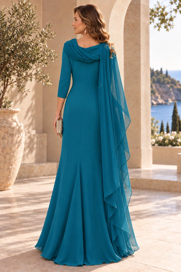 Back view of teal blue mother of the bride gown featuring draped shoulder neckline, cascading sheer cape panel, fitted waist and flowing floor-length skirt