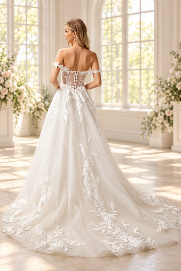 Back view of Vedress A-line wedding dress showing a sheer corset-style bodice, covered buttons and a sweeping floral lace applique train.