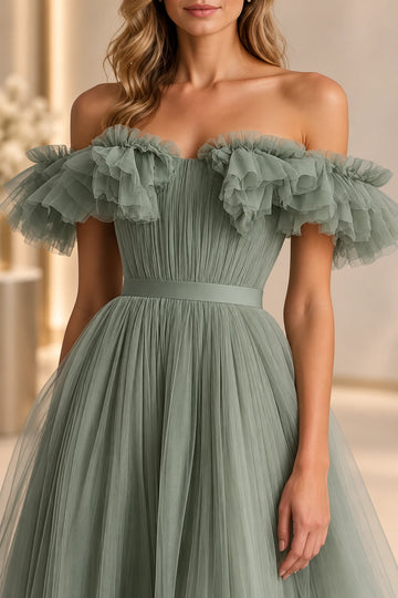 Close-up of a Vedress sage green prom dress showing layered tulle ruffles, fine vertical bodice gathers and a smooth waistband