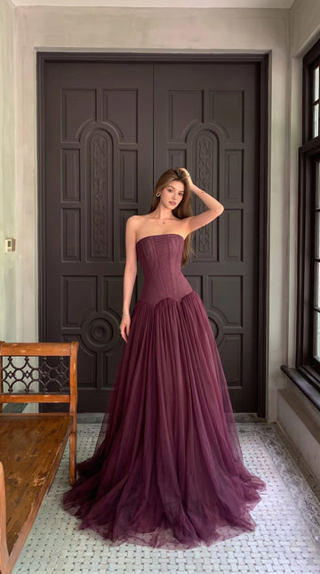 Vedress Mulberry strapless wedding guest dress with a structured corset bodice, low waist and flowing pleated tulle ball gown skirt.