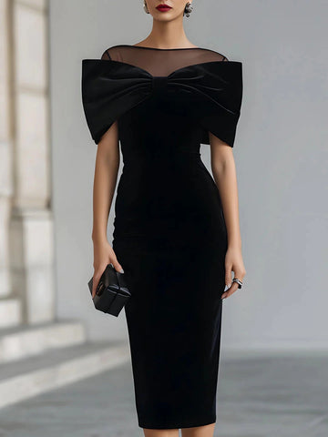 Vedress black mother of the bride dress with a sheer illusion neckline, oversized off-shoulder bow and fitted midi silhouette.