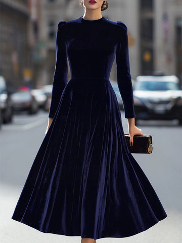 Vedress navy blue velvet mother of the bride dress with a jewel neckline, puff-shoulder long sleeves and flared midi skirt.