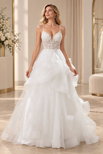 Vedress A-line wedding dress with a plunging V-neck, sheer-effect lace bodice, thin straps and cascading ruffled skirt.