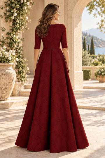 Back view of wine floral mother of the bride dress with high covered zipper back, fitted waist, half sleeves and flowing floor-length A-line skirt