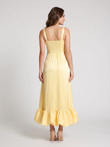 Pale yellow maxi wedding guest dress with wide straps smocked back and gathered ruffle hem by Vedress
